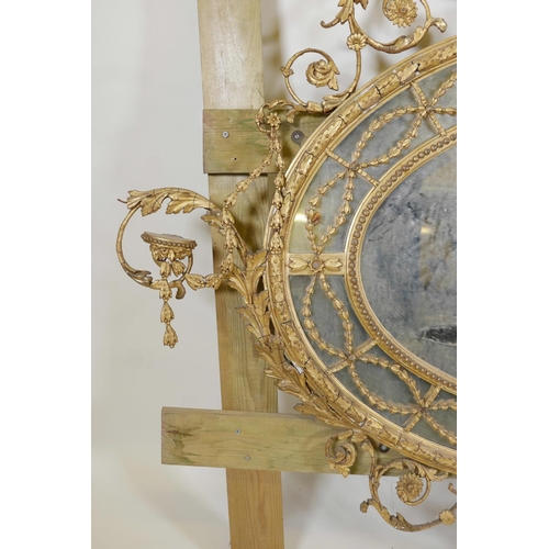 1013 - A C19th Adam style giltwood and composition sectional wall mirror, A/F, 60