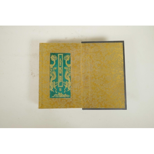 102 - A Chinese wood and material bound book containing jade tablets with engraved and gilt character insc... 