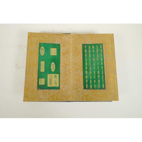 102 - A Chinese wood and material bound book containing jade tablets with engraved and gilt character insc... 