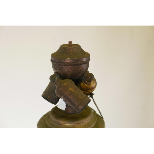 1023 - A metal and plaster standard lamp painted over what appears to be a copper and brass metal sheath, e... 