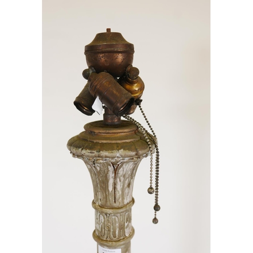 1023 - A metal and plaster standard lamp painted over what appears to be a copper and brass metal sheath, e... 