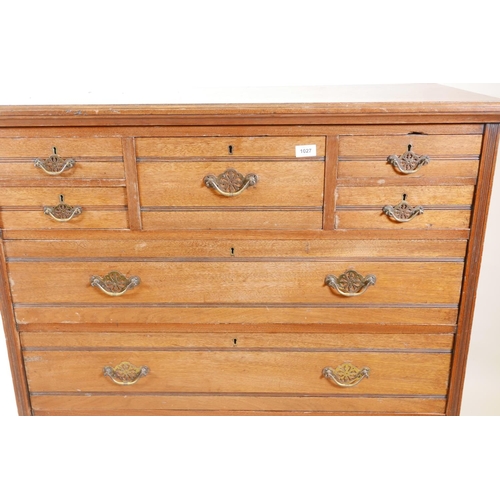 1027 - A 1920s walnut chest of drawers, five small over three long drawers, with reeded decoration, 41