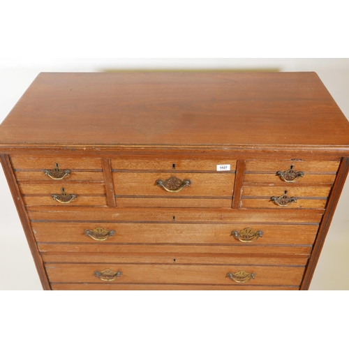 1027 - A 1920s walnut chest of drawers, five small over three long drawers, with reeded decoration, 41