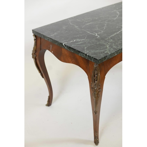 1031 - A mahogany coffee table with an adapted vert de mer style top and gilt metal mounts, 35