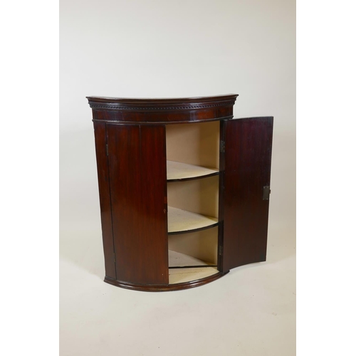 1037 - A Georgian mahogany hanging corner cupboard, 18