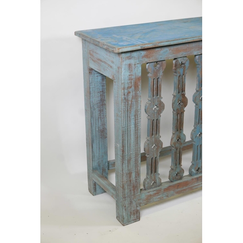 1041 - An Indian hardwood console table with carved and pierced front and distressed paintwork, 61