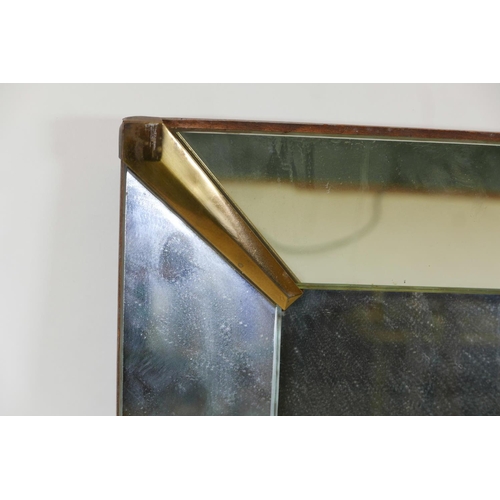 1042 - A mid century sectional wall mirror with brass corner mounts, 51