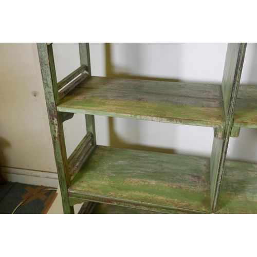 1043 - An Indian hardwood open shelf/rack with distressed paintwork, 60