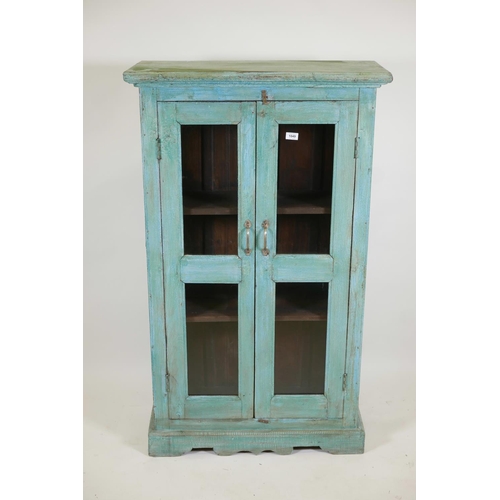 1049 - An Indian painted hardwood two door display cabinet, 32