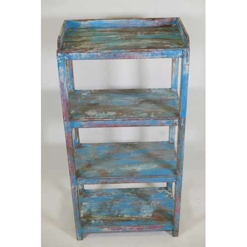 1050 - An Indian hardwood four tier open shelf with distressed paintwork, 23