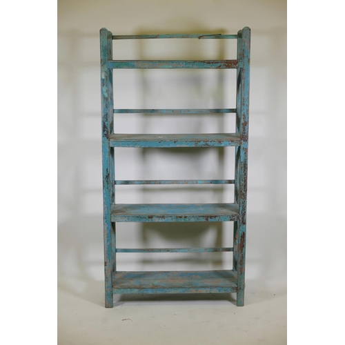 1053 - An Indian hardwood four tier open shelf with distressed paintwork, A/F minor break, 36