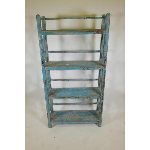 1053 - An Indian hardwood four tier open shelf with distressed paintwork, A/F minor break, 36