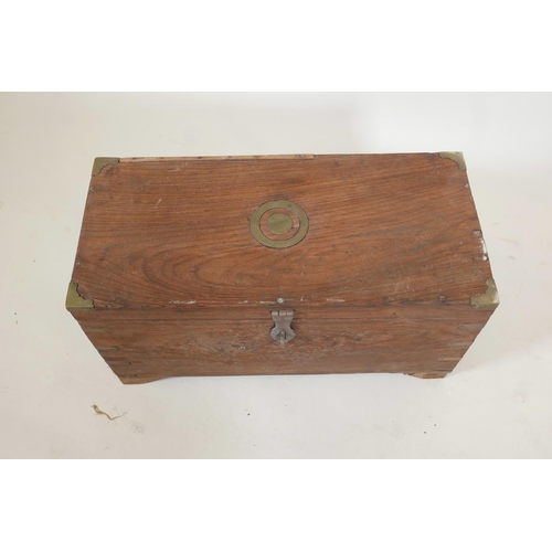 1057 - An Indian teak box with brass mounts, fitted with three trays, later supports, 12