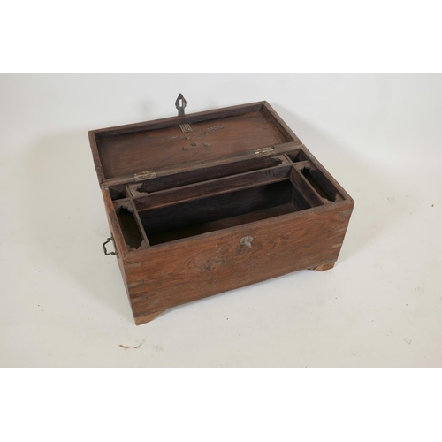 1057 - An Indian teak box with brass mounts, fitted with three trays, later supports, 12