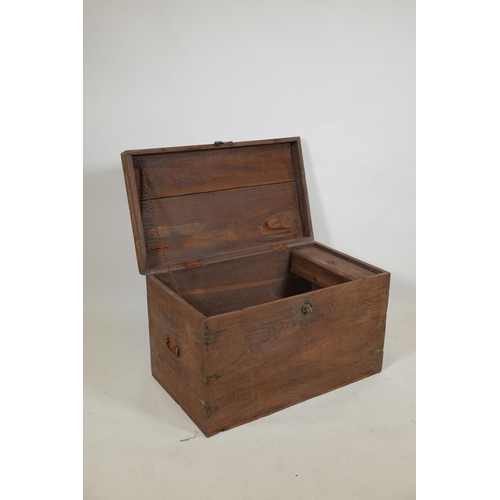 1058 - An Indian teak blanket box, with brass mounts, the interior fitted with a candle box, 30