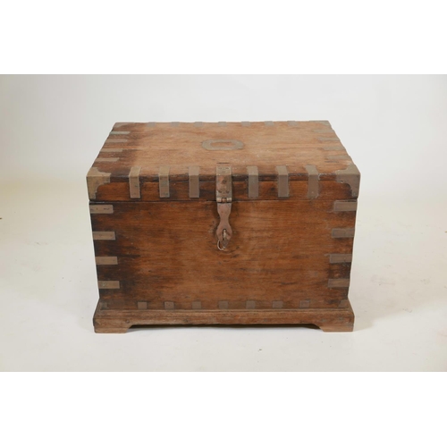 1060 - An Indian teak blanket box with brass mounts and shaped plinth base, 27