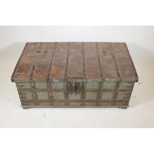 1061 - An Indian teak chest with iron strapwork and hinged fold over top, and traces of original paint, 49