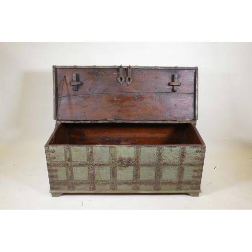 1061 - An Indian teak chest with iron strapwork and hinged fold over top, and traces of original paint, 49