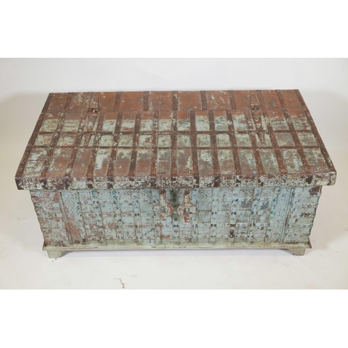 1062 - An Indian teak dowry chest with iron strap work wand hinged fold over top, with original distressed ... 