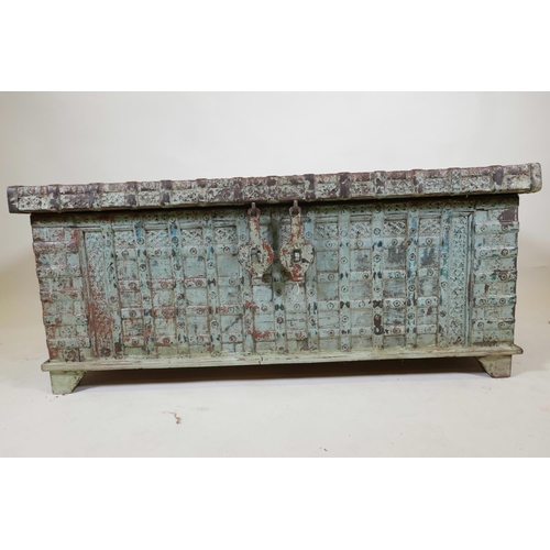 1062 - An Indian teak dowry chest with iron strap work wand hinged fold over top, with original distressed ... 