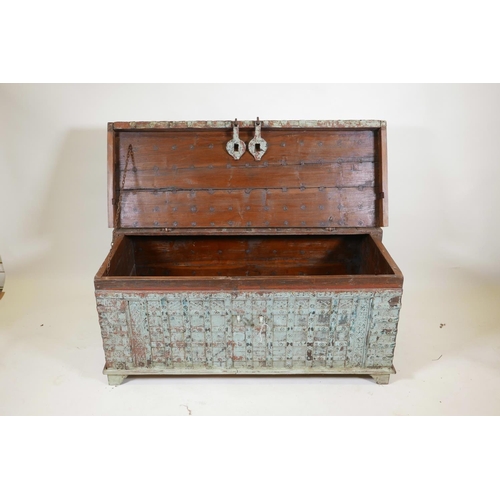 1062 - An Indian teak dowry chest with iron strap work wand hinged fold over top, with original distressed ... 