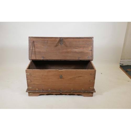 1064 - An Indian teak and brass mounted chest with decorative studs and half hinged fold over top, raised o... 