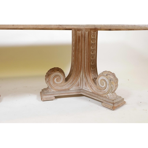 1065 - An Indian teak coffee table, with carved frieze, raised on two scrolled end supports, the top rebate... 