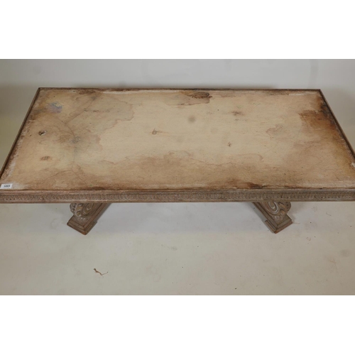 1065 - An Indian teak coffee table, with carved frieze, raised on two scrolled end supports, the top rebate... 