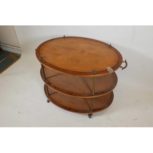 1066 - A satinwood three tier etagere, with rosewood banded and ebony strung tops, and brass handles, raise... 