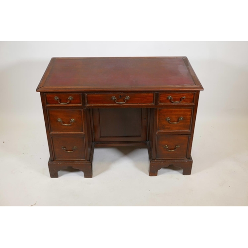 1069 - A C19th mahogany seven drawer kneehole desk, with inset blind tooled leather top and brass swan neck... 