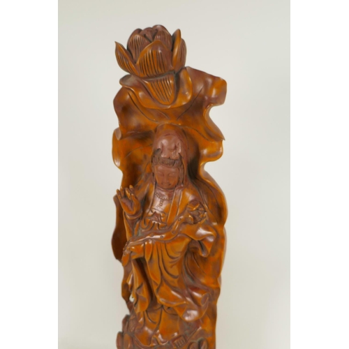 107 - A Chinese carved wood figure of Guan Yin standing on a lotus throne, 20