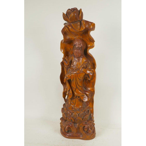 107 - A Chinese carved wood figure of Guan Yin standing on a lotus throne, 20