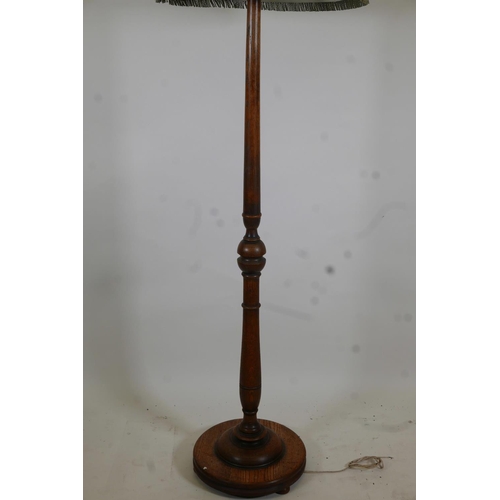 1070 - A carved and turned oak standard lamp, 62