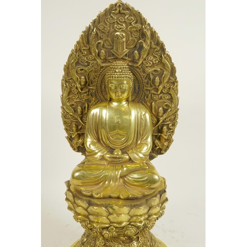 108 - A Chinese polished brass Buddha seated on a lotus throne, 4 character mark to base, 15