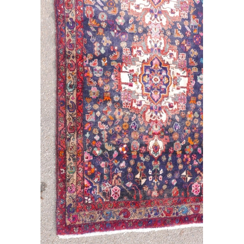 1083 - A Persian thick pile blue ground runner with a multicoloured floral design, 50½