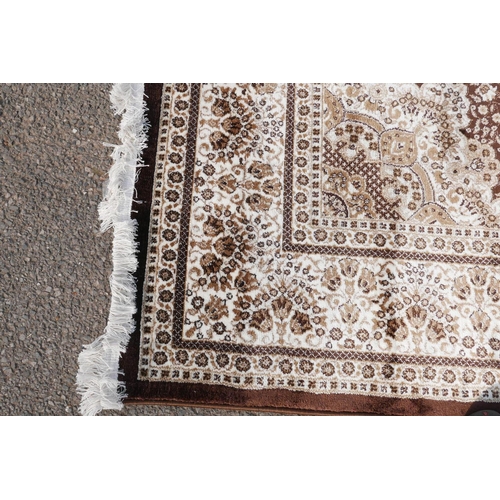 1085 - A Turkish brown ground thick pile carpet decorated with a floral medallion design and cream borders,... 