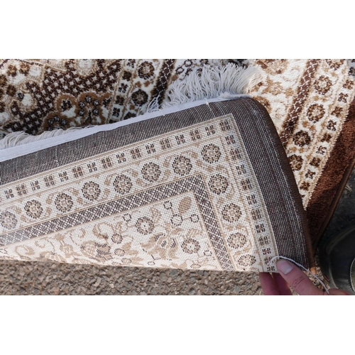 1085 - A Turkish brown ground thick pile carpet decorated with a floral medallion design and cream borders,... 