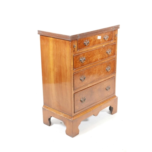 1088 - A walnut Reprodux bachelor's chest with four long drawers, raised on bracket feet, 23½