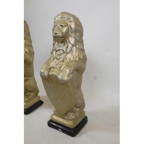 1090 - A pair of gilt moulded concrete garden lions, 31