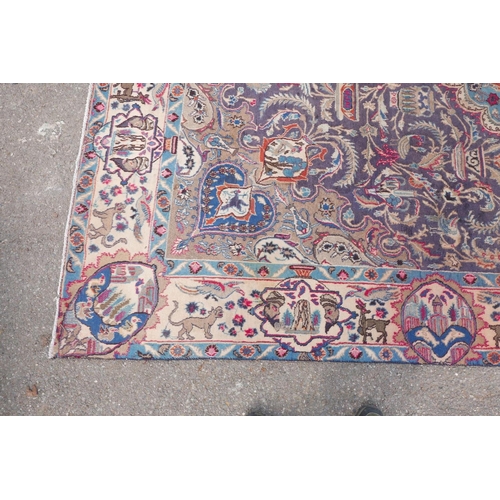 1092 - A vintage Persian Kashmar carpet decorated with a floral medallion on a purple ground, and a cream b... 