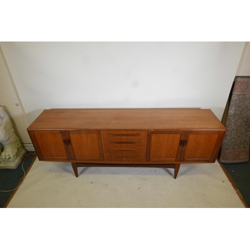 1096 - A mid century G-Plan teak 'Fresco' sideboard with a bank of four drawers flanked by cupboards, desig... 