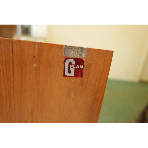 1096 - A mid century G-Plan teak 'Fresco' sideboard with a bank of four drawers flanked by cupboards, desig... 