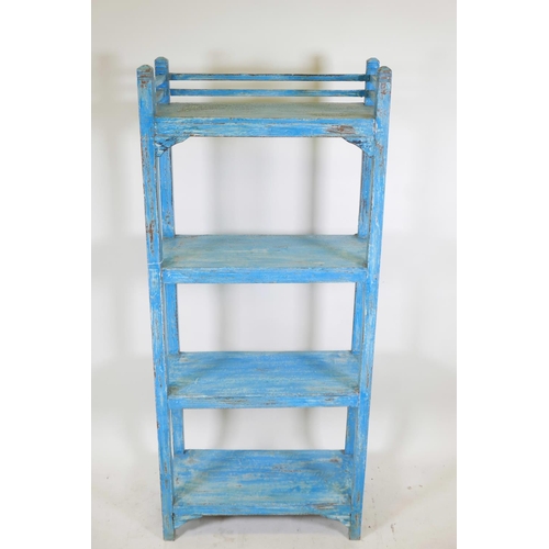 1100 - An Indian hardwood four tier open shelf with distressed paintwork, 20