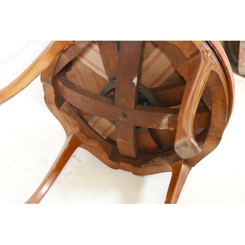 1111 - A C19th Art Nouveau, walnut, tub shaped swivel armchair, with carved and pierced, shaped back, scrol... 