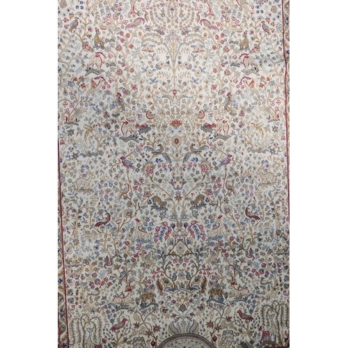 1117 - A cream ground Kashmir rug with a traditional tree of life design and a blue border, 62