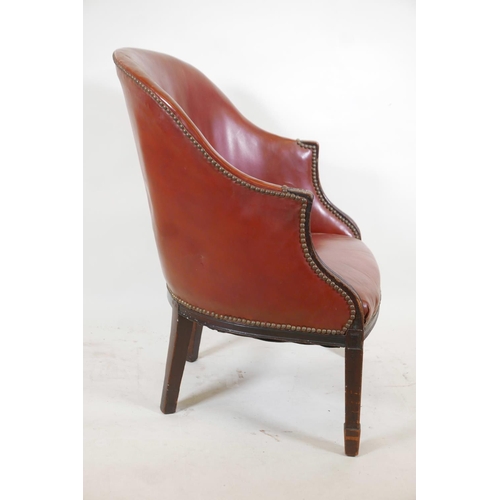 1118 - A mahogany framed armchair with brass studded leather upholstery, and bow shaped front, raised on sq... 