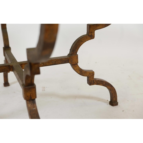 1119 - A gilded steel framed occasional table with shaped supports, cross stretcher and tinted glass top, 3... 