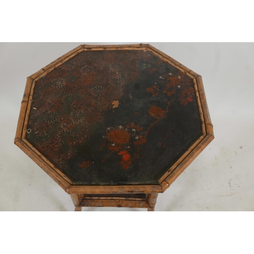 1132 - An Oriental octagonal bamboo occasional table with a lacquer top and undertier decorated with birds ... 