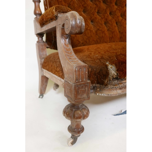 1134 - A C19th walnut frame settee with carved open arms, raised on gadrooned front feet and sabre back leg... 