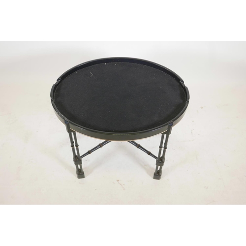 1135 - A Regency style ebonised and parcel gilt faux bamboo tray stand, with oval top, raised on cluster co... 